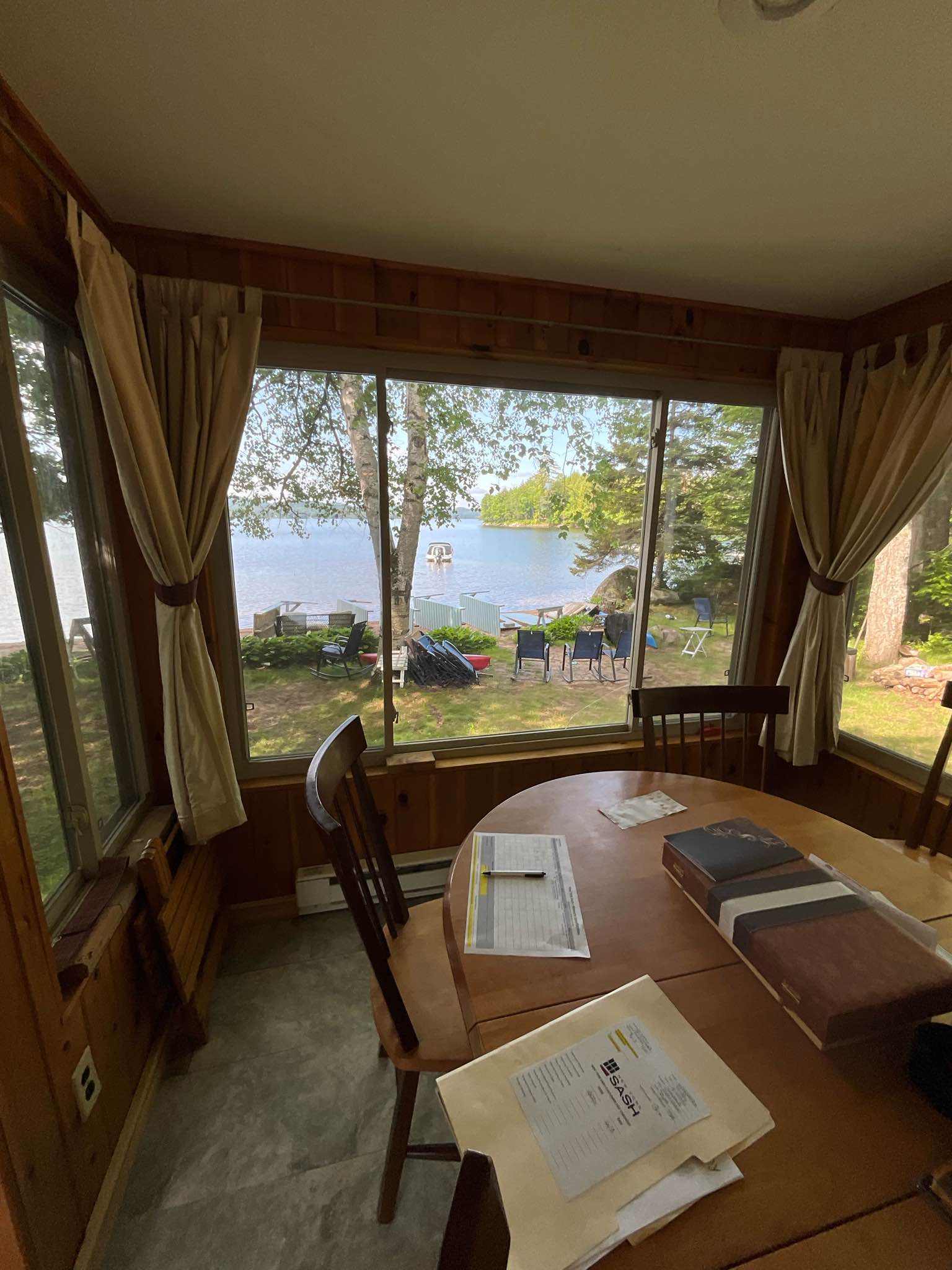 Interior view toward the lake before the project, with heavy window frames interrupting the water view